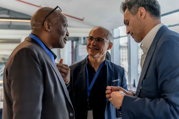 Three delegates deep in conversation