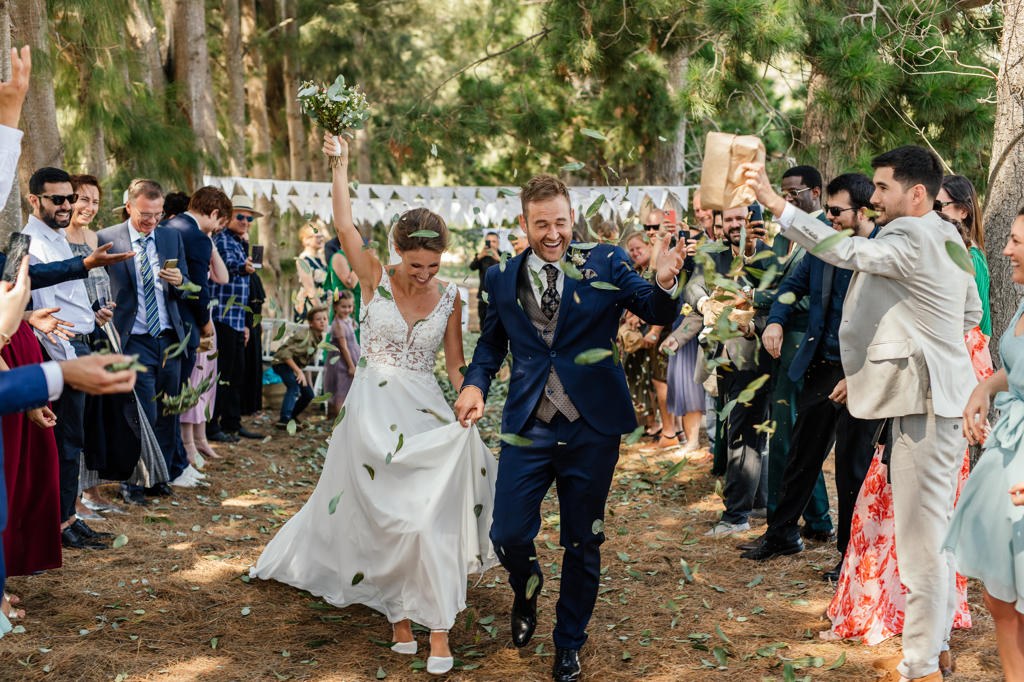 Newlyweds walking out through their guests after the ceremony