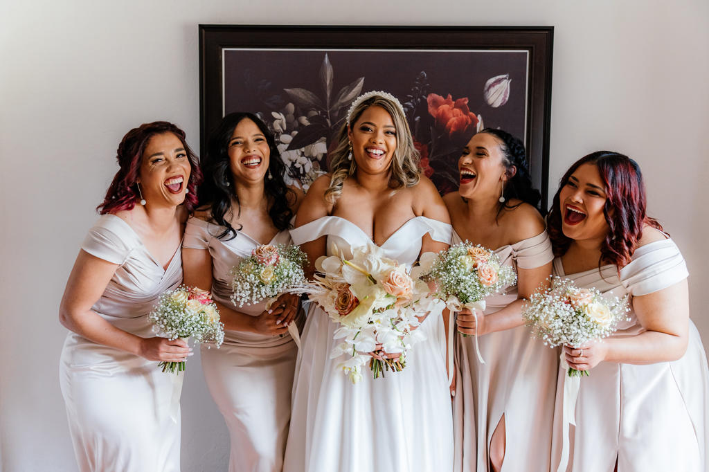 The bride laughing with her bridesmaids in blush dresses, Ulrich and Keshia's wedding