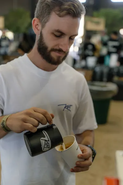 The Kort Coffee barista pouring milk into a cup, Kort Coffee