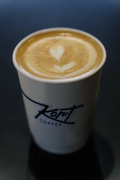 A Kort Coffee takeaway cup with a flat white, Kort Coffee