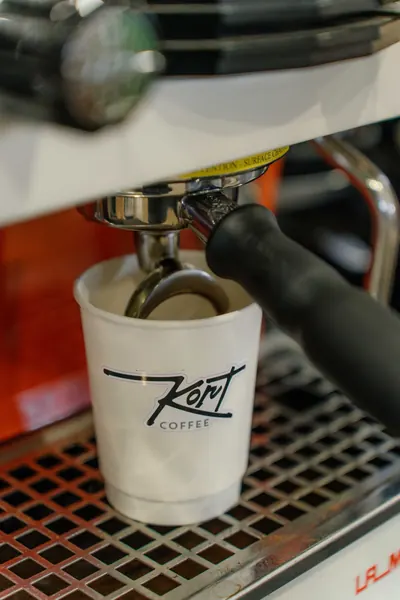 Espresso running into a Kort Coffee cup at the machine, Kort Coffee