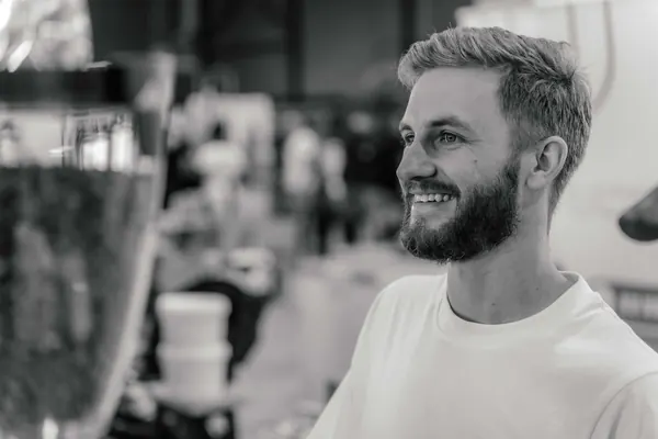Black-and-white portrait of the barista smiling, Kort Coffee