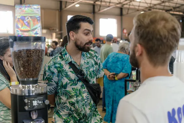 The barista serving customers at the grinder, Kort Coffee