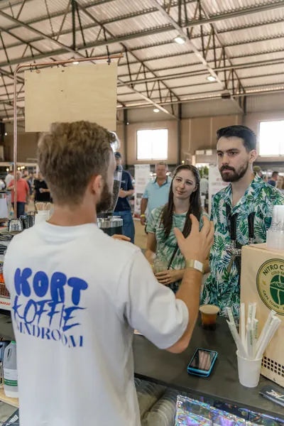 The barista serving customers at the grinder, Kort Coffee