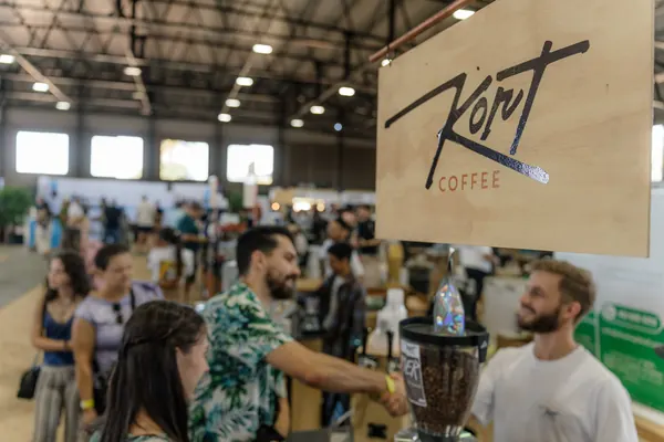 A busy crowd under the Kort sign, Kort Coffee