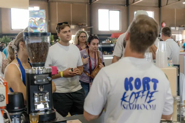 Customers chatting with the barista over a coffee, Kort Coffee