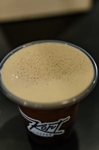 Cold brew with a creamy head in a Kort Coffee cup