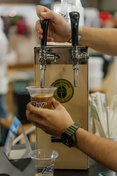 Cold brew poured from a tap into a cup