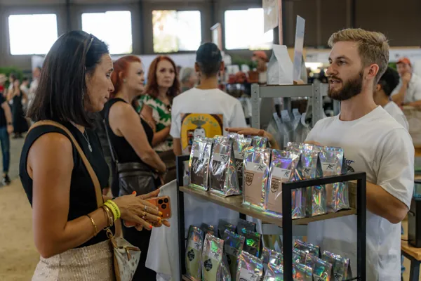 A customer choosing from the bags of coffee on display